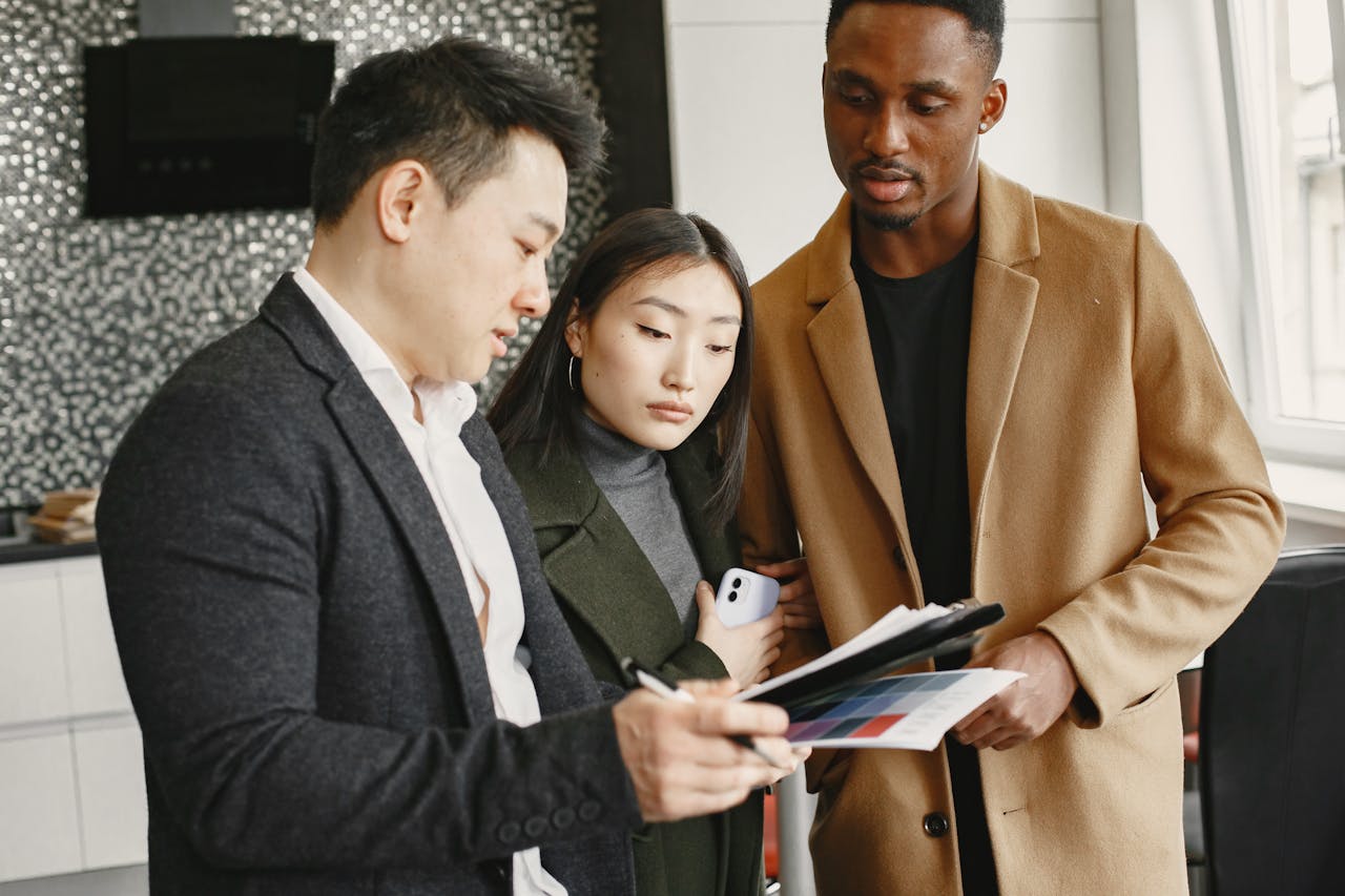 Diverse business team collaborating on document review in a modern office setting.